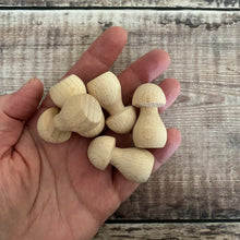 Load image into Gallery viewer, 41mm wooden mushrooms in hand for scale
