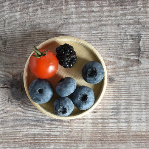 Wooden coaster with blueberries